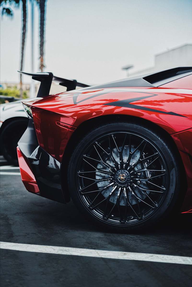 sports car black and red Lamborghini Aventador SV rear left side wheel